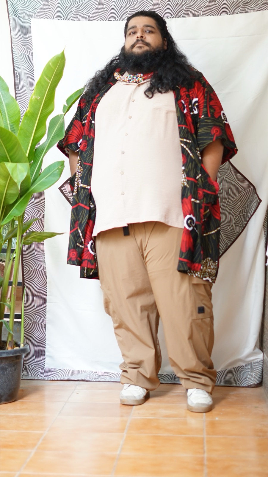 The floral kimono worn open over a pale shirt