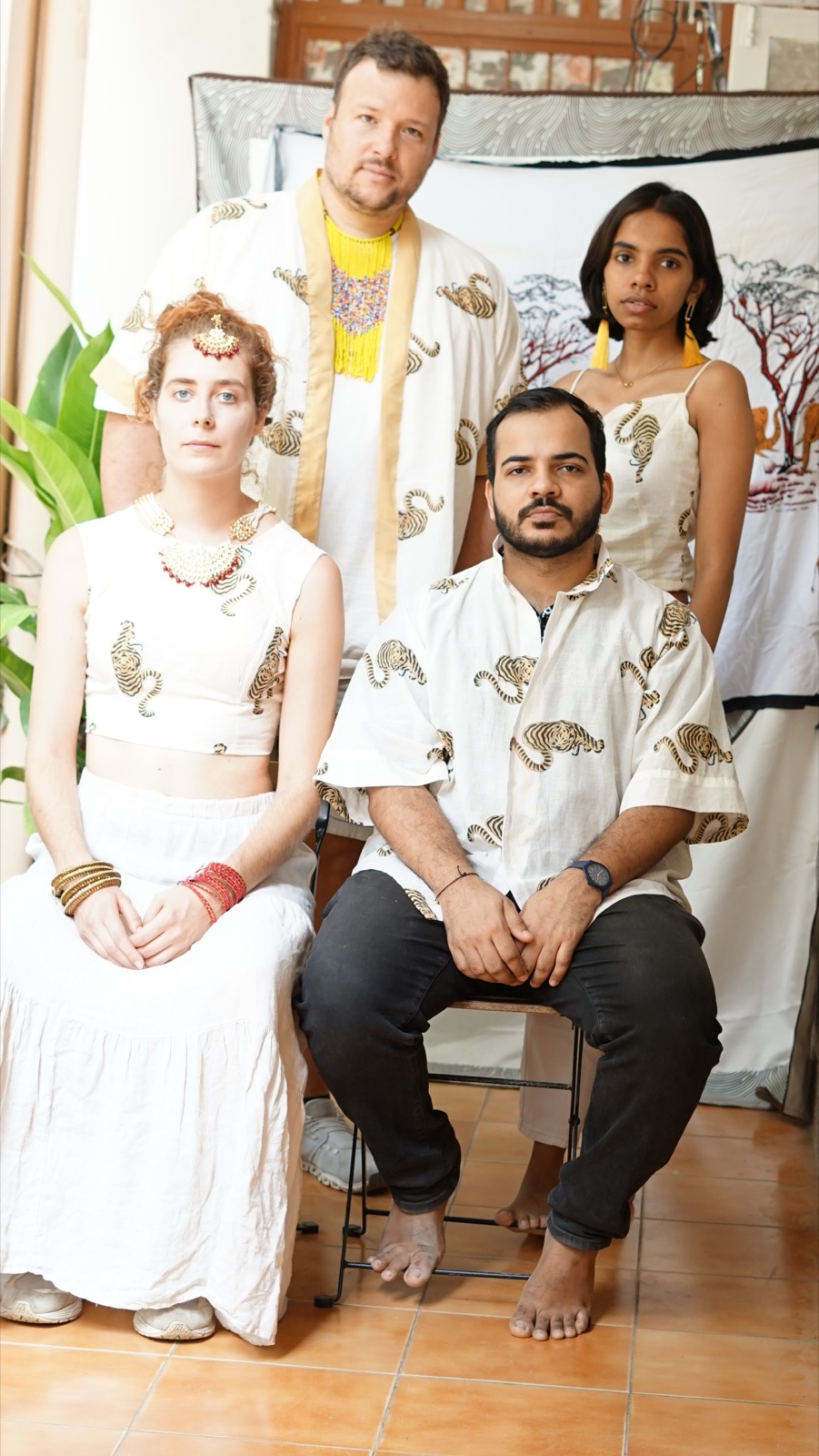 Four people in cream block-print crop tops and shirts